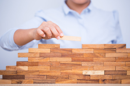 Woman build a tower puzzleの写真素材