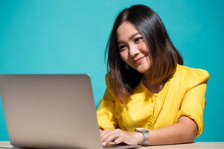Woman feel shy when she look at laptopの写真素材