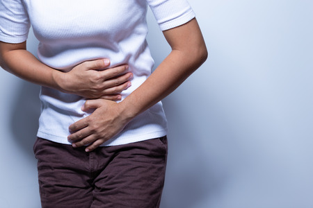 Woman has stomach acheの写真素材