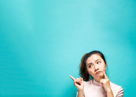 Portrait of serious woman on a blue backgroundの写真素材