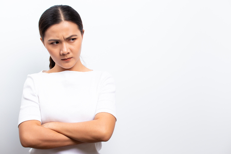 Angry woman standing isolated over whiteの写真素材