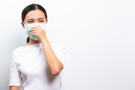 Asian women wear protective masks isolated over whiteの写真素材