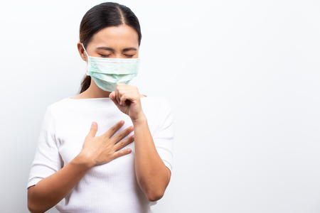 Asian women wear protective masks isolated over whiteの写真素材
