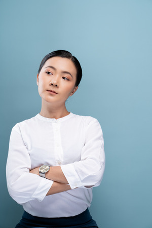 Portrait of a confident woman standing isolated over backgroundの写真素材