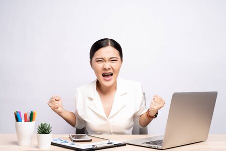 Angry woman screaming at office isolated over backgroundの写真素材