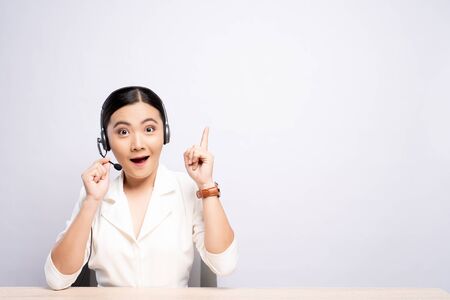 Woman operator in headset with blank copy space isolated white backgroundの写真素材