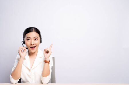 Woman operator in headset with blank copy space isolated white backgroundの写真素材
