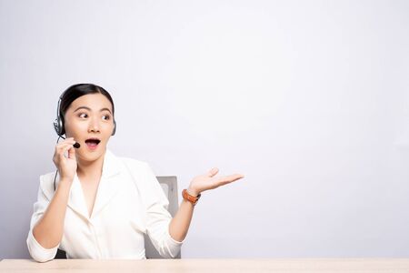 Woman operator in headset with blank copy space isolated white backgroundの写真素材