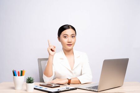 Portrait of a woman has positive thinking sitting at office isolated over backgroundの写真素材
