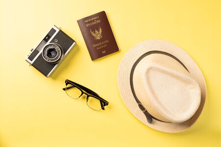 Top view summer concept with accessories on yellow background with copy spaceの写真素材