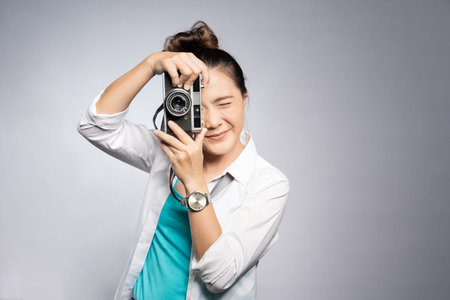Happy woman take a photo by camera isolated over background