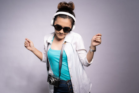 Tourist woman listening music isolated over white backgroundの写真素材