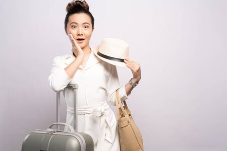 Tourist woman with suitcase isolated on white backgroundの写真素材