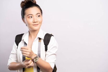 Happy woman holding camera over backgroundの写真素材