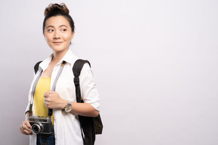 Happy woman holding camera over background