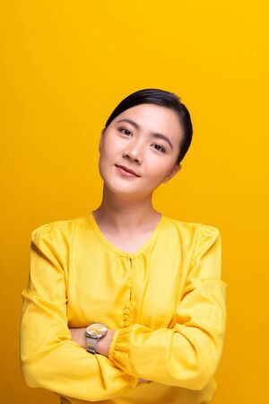 Portrait of a confident woman standing isolated over backgroundの写真素材