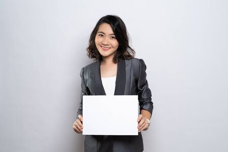 Business woman showing paper isolated over white backgroundの写真素材