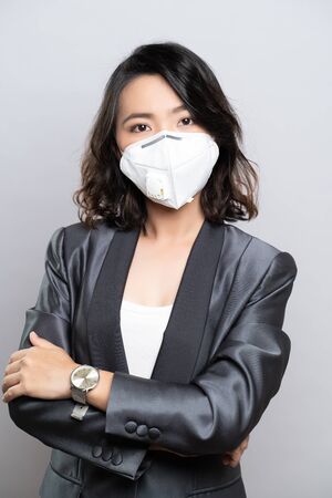 Businesswoman wearing the N95 mask isolated over white backgroundの写真素材