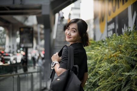 Portrait of happy asian woman in the cityの写真素材