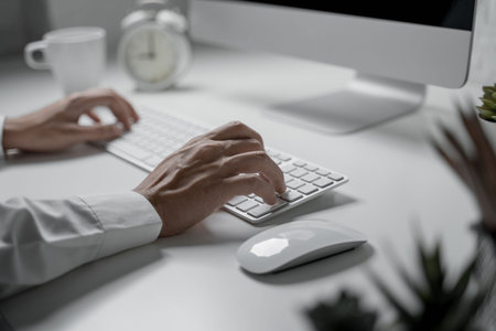 Close up shot of businessman use computer typing message on keyboard