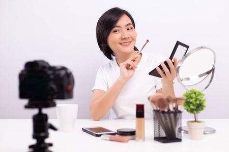 Beauty blogger is showing how to  make up while recording videoの写真素材