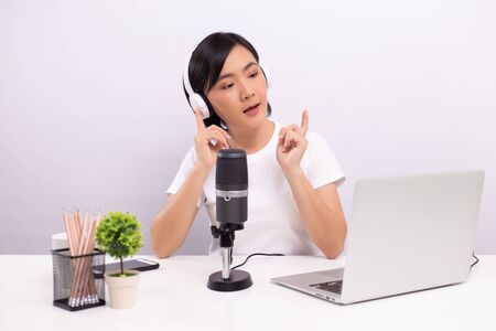 Woman blogger speaking in front of camera and recording video for social media