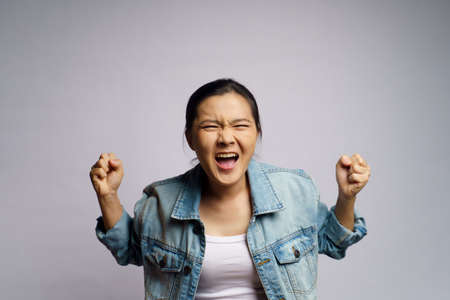 Asian woman angry and shouting isolated on white background.の写真素材