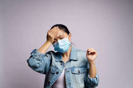 Asian woman wearing protective face mask was sick with headache isolated on white background.