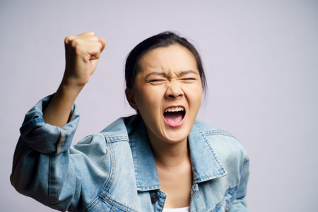 Asian woman shouting isolated on white background.