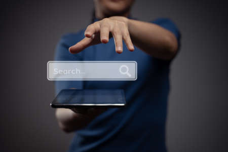 Woman using tablet showing with home icon hologram effect.の写真素材