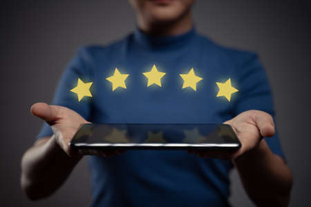 Woman using tablet planning digital marketing with chart hologram effect.の写真素材