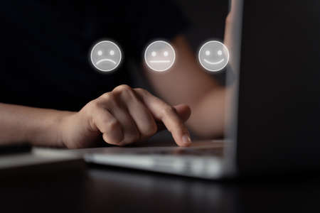 Woman using laptop for upload with cloud icon hologram effect.の写真素材