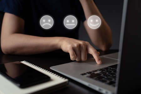 Woman using laptop for upload with cloud icon hologram effect.の写真素材