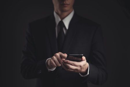 Close up shot of businessman in black suit. Elegant handsome on black background.の写真素材