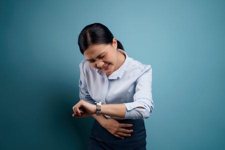 Asian woman happy surprised standing with copy space isolated on blue background.の写真素材