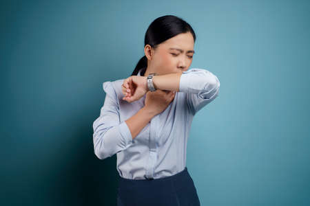 Asian woman was sick with eyes pain, irritate itching her eyes, isolated on background.の写真素材