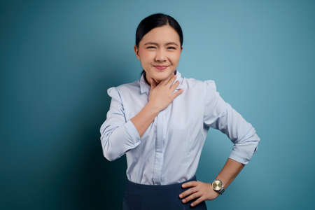 Asian woman was sick with eyes pain, irritate itching her eyes, isolated on background.の写真素材