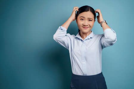 Asian woman was sick with eyes pain, irritate itching her eyes, isolated on background.の写真素材