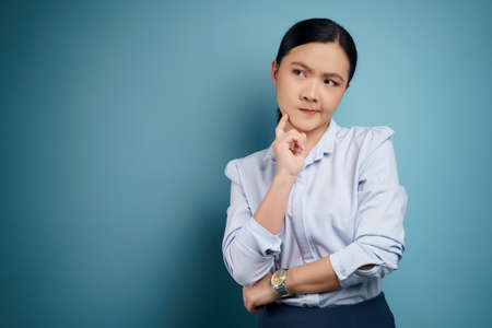 Asian woman was sick with eyes pain, irritate itching her eyes, isolated on background.の写真素材