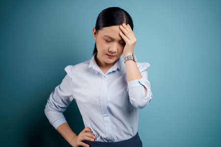 Asian woman was sick with eyes pain, irritate itching her eyes, isolated on background.の写真素材