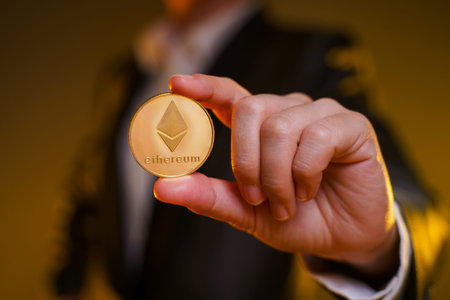 Close up shot of Business woman in black suit holding golden coin isolated on background.