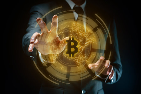 Close up shot of Businessman in black suit with bitcoin symbol hologram effect isolated on background.の写真素材