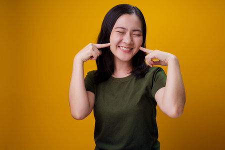 Asian woman standing and angry isolated over yellow background.