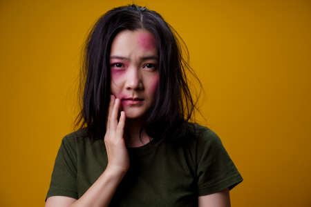 Asian woman standing and angry isolated over yellow background.の写真素材