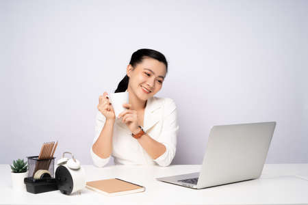 Asian woman working at officeusing smart phone for relaxing. Business with technology concepts.の写真素材