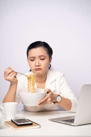 Asian woman working at officeusing smart phone for relaxing. Business with technology concepts.の写真素材