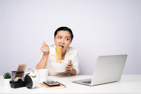 Asian woman working at officeusing smart phone for relaxing. Business with technology concepts.の写真素材