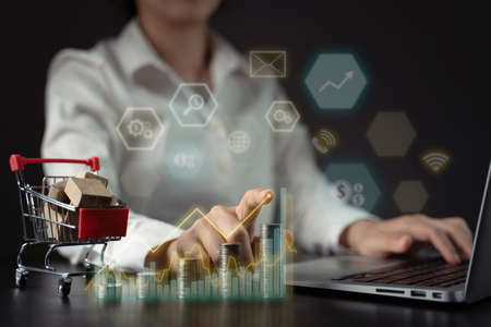 Concepts of economic technology future business Eco friendly new trading platform. Businessman with coin stack and hologram chart.の写真素材