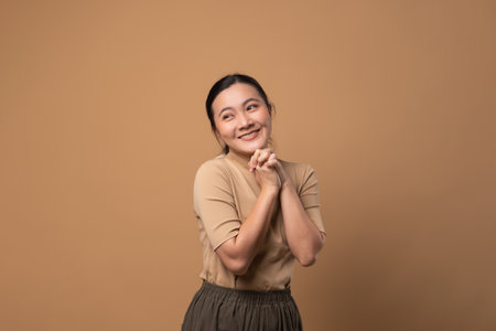 Asian woman happy confident ,looking at camera, isolated on beige background.の写真素材