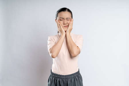 Asian woman happy confident smiling, looking at camera, standing isolated on white background.の写真素材